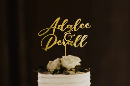 thin calligraphy personalized golden cake topper made of wood on top of the white simple wedding cake. 